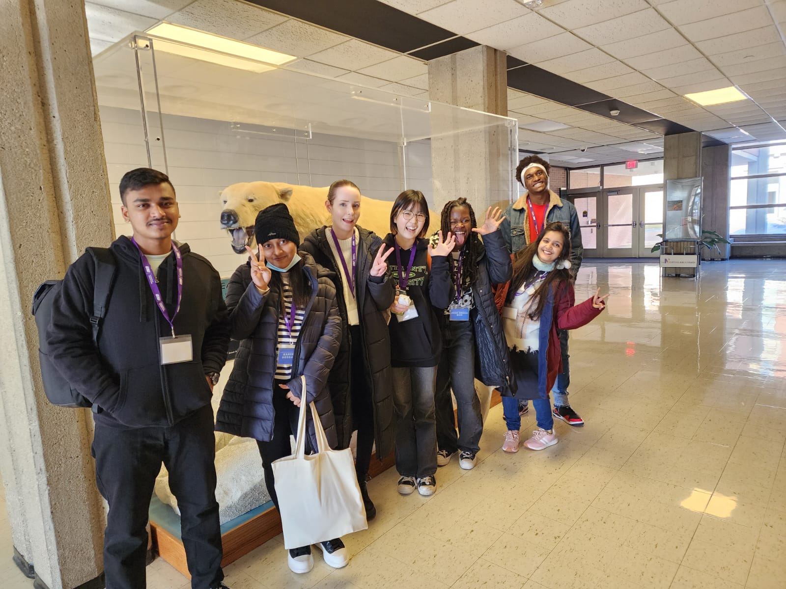 New 2023 international students next to the polar bear display in the ARTIC Center on the UNI campus